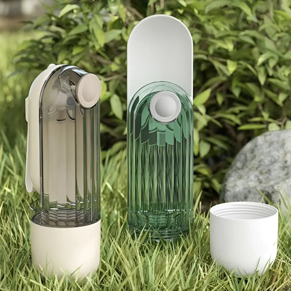 Two translucent ribbed pet water cups in muted gray-green and emerald green with white caps for green dog walking