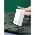 White portable handheld hanging ironing machine with transparent water tank and sleek cylindrical design with folding handle