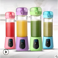 Four colorful portable mini electric juice cup glass blenders with transparent bodies and vibrant lids in pink purple green and blue