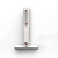 A sleek portable self-squeezing mini mop with absorbent cotton head in white and gray with rose gold accents