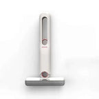A sleek portable self-squeezing mini mop with absorbent cotton head in white and gray with rose gold accents