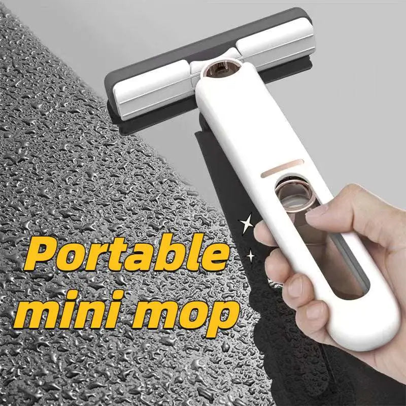 Portable self-squeezing mini mop with a white absorbent cotton head and dual-sided black rubberized cleaning edges