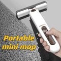 Portable self-squeezing mini mop with a white absorbent cotton head and dual-sided black rubberized cleaning edges