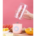Pink cylindrical portable usb automatic mini juicer with light blue button and metallic blade assembly for glass cups