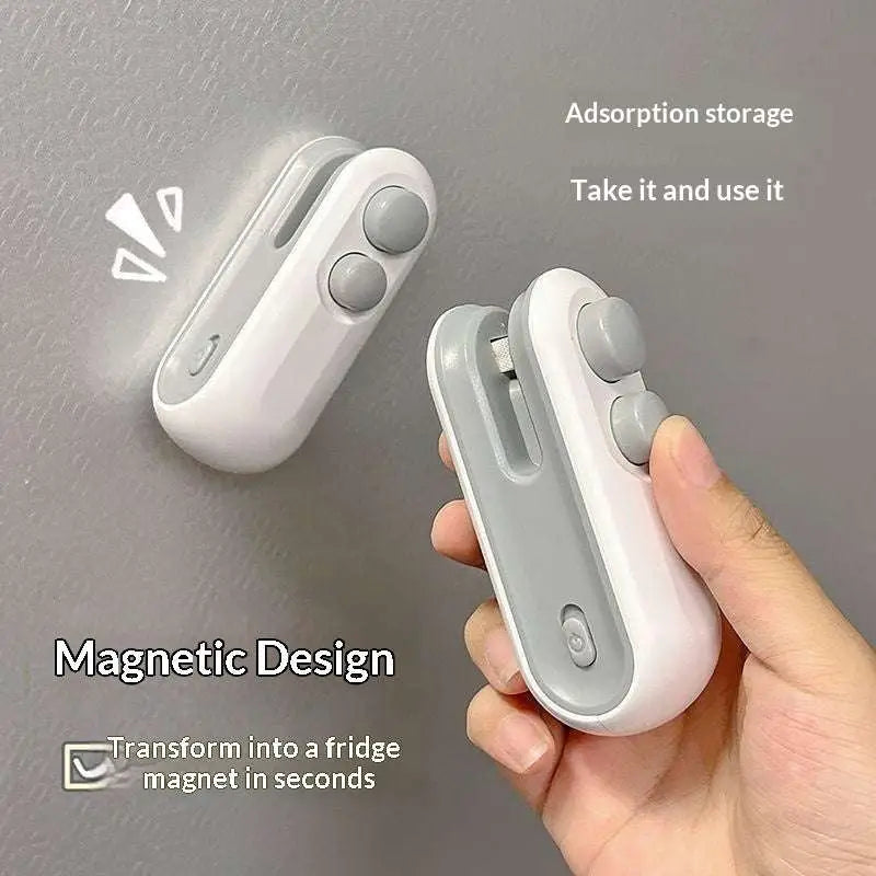 White and gray magnetic storage clip with ergonomic design for easy fridge attachment in portable usb heat sealer set