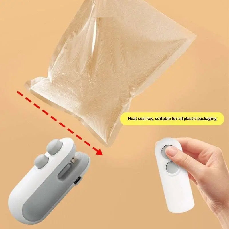 White and gray handheld portable usb heat sealer with magnetic storage clip for sealing plastic packaging