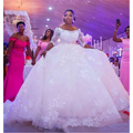 White off-the-shoulder pregnant women princess wedding dress with voluminous skirt and intricate lace sleeves detailing