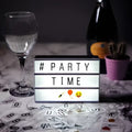 A black-framed premium led cinema lightbox displaying party time with emojis illuminated against a dark background