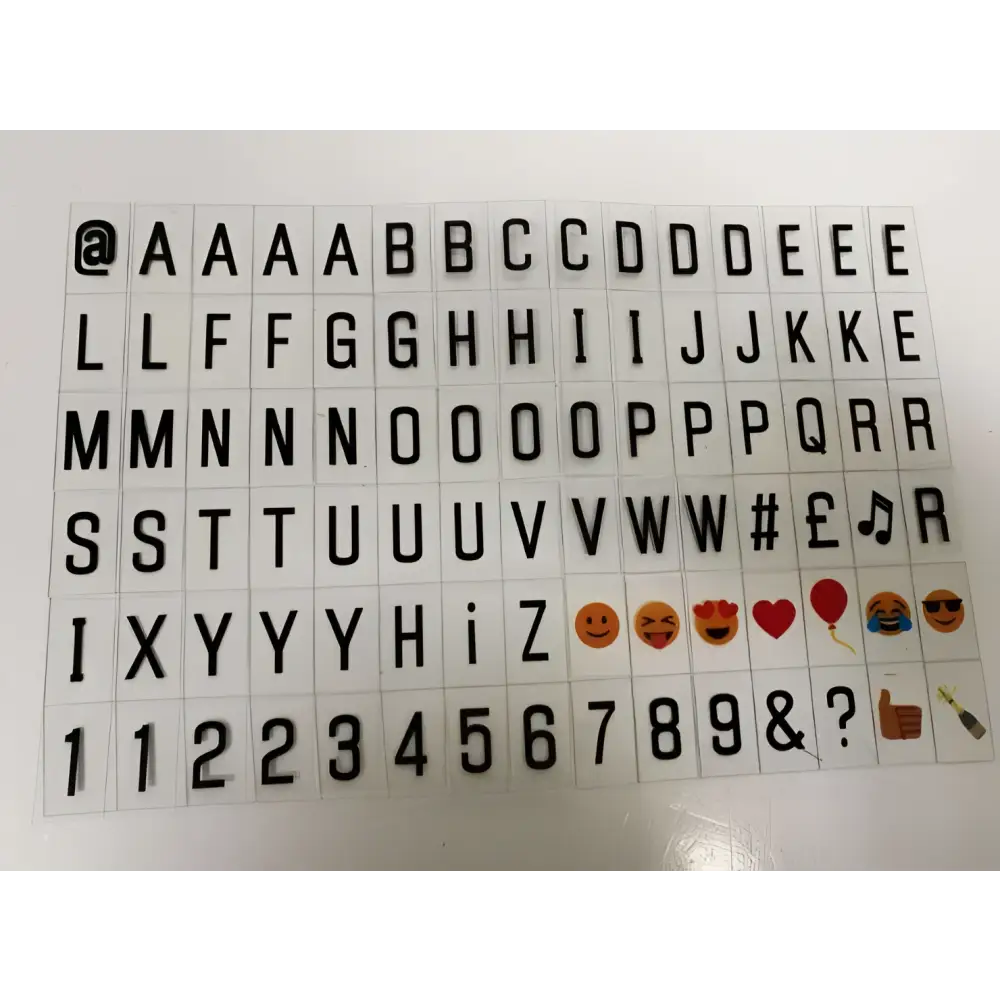 Black 3d-printed alphabet and emoji stickers on transparent backing for premium led cinema lightbox accessory