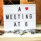 White premium led cinema lightbox with black letter tiles and a red heart emoji displaying a meeting at 6 message