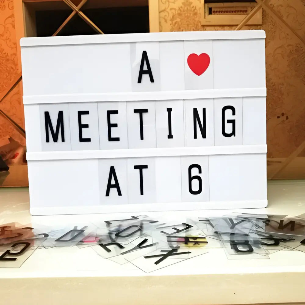White premium led cinema lightbox with black letter tiles and a red heart emoji displaying a meeting at 6 message