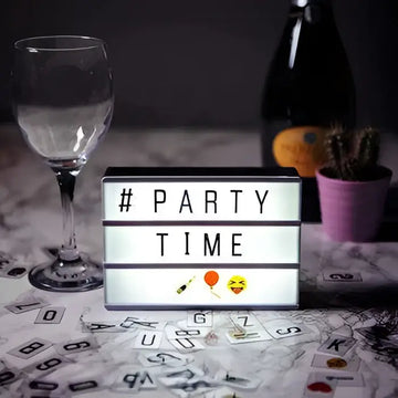 Black-framed premium led cinema lightbox displaying hashtag party time with emojis against a dark background