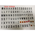 Black plastic letter and emoji stickers in a grid for premium led cinema lightbox featuring letters numbers symbols and colorful emojis