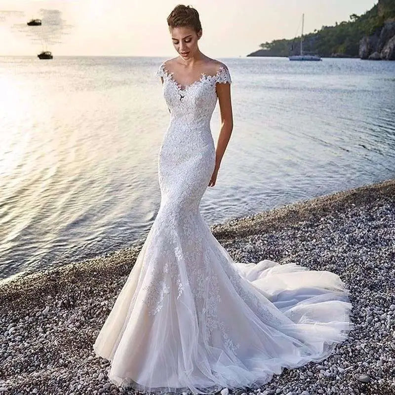 White lace princess bride mermaid wedding dress with off-the-shoulder sleeves and flowing train for brides