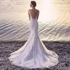 White lace princess bride mermaid wedding dress with open back beaded detailing and flowing train shown from the back