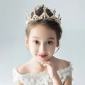 A delicate silver princess girl diamond crown crystal headband adorned with sparkling crystals and intricate filigree