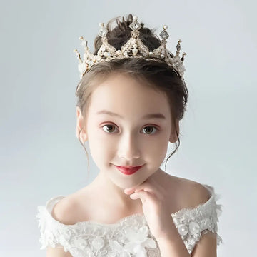 A delicate silver princess girl diamond crown crystal headband adorned with sparkling crystals and intricate filigree