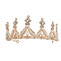 A delicate gold-toned princess girl diamond crown crystal headband adorned with intricate filigree and pink pearls