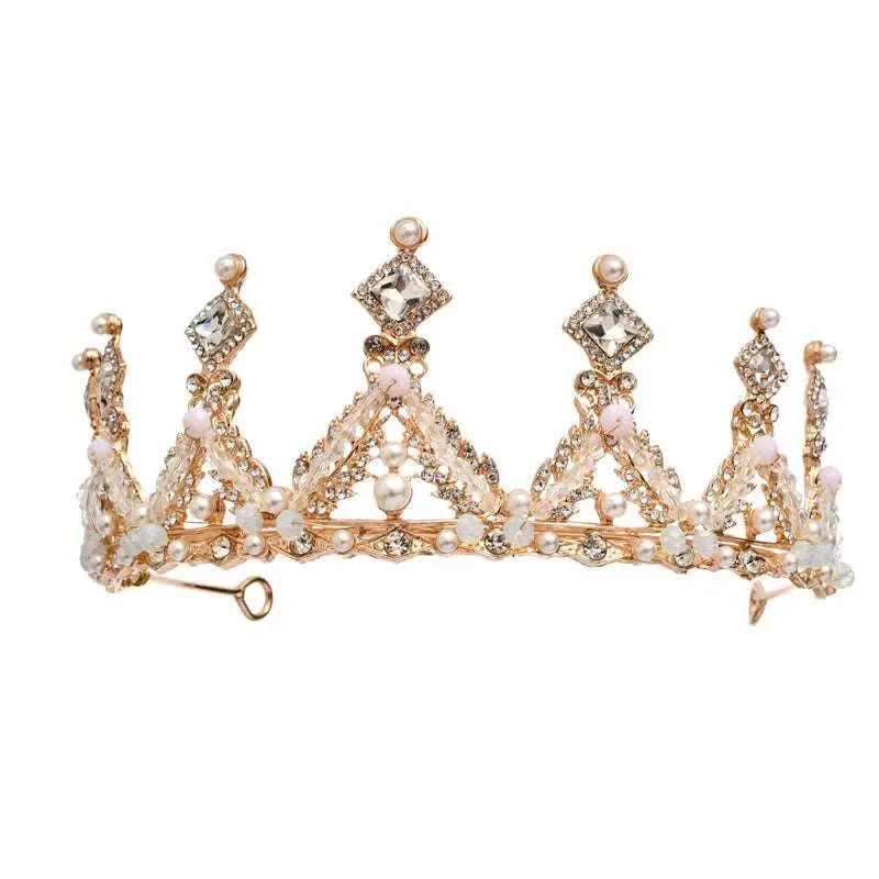 A delicate gold-toned princess girl diamond crown crystal headband adorned with intricate filigree and pink pearls