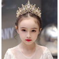 A delicate gold princess girl diamond crown crystal headband adorned with sparkling crystals and intricate filigree pearls