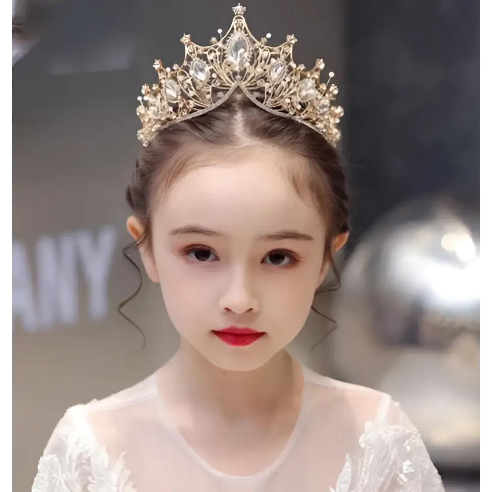 A delicate gold princess girl diamond crown crystal headband adorned with sparkling crystals and intricate filigree pearls