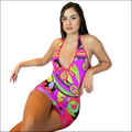 A vibrant sleeveless halterneck dress in bold pink and purple with a psychedelic floral pattern perfect for summer events