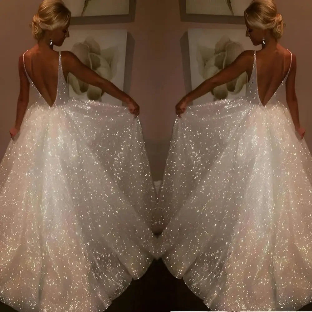 Pure white sequined wedding evening dress with a deep v-back and a flowing skirt shown from the back side