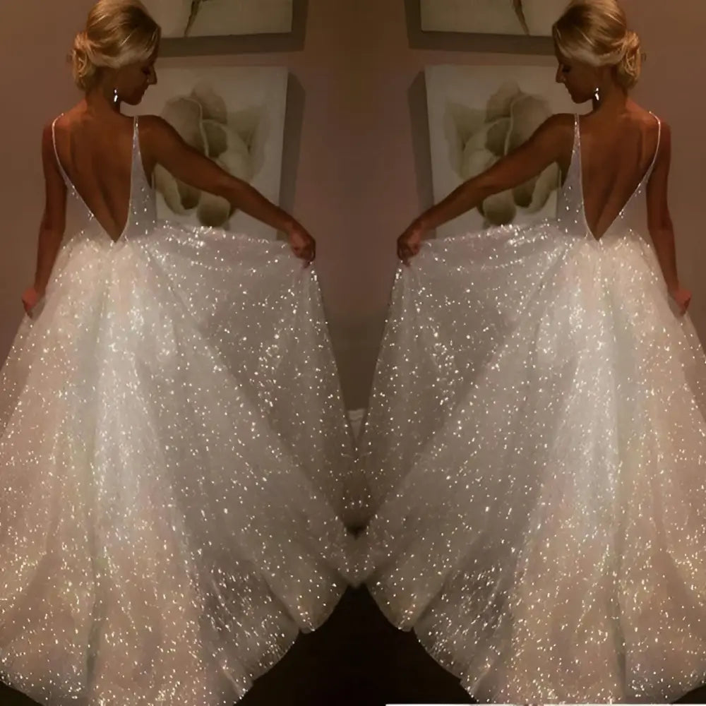 Pure white sequined wedding evening dress with a deep v-back and flowing skirt shown from the back side