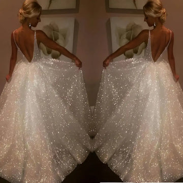 Pure white sequined wedding evening dress with a deep v-back and flowing skirt shown from the back side