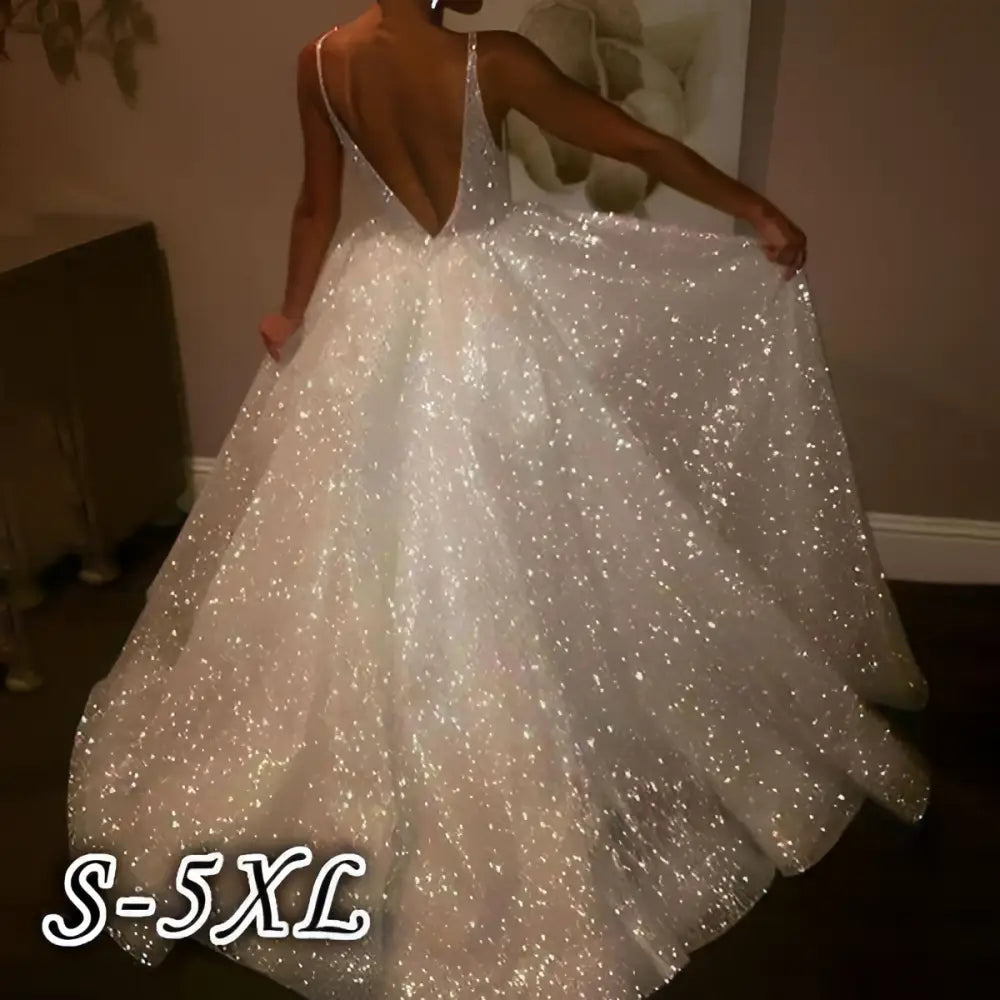 Pure white sequined wedding evening dress with a deep v-back and flowing skirt shown from the back side