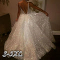 Pure white sequined wedding evening dress with a deep v-back and a flowing skirt shown from the back side