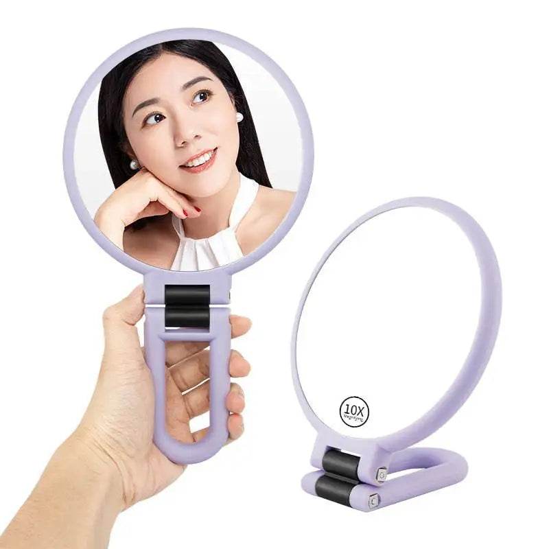 Lavender-colored foldable handle mirror with 10x magnification and ergonomic grip for detailed personal care