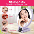 Lavender-colored foldable handle mirror with 10x magnification designed for precise makeup application