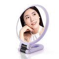 Lavender-colored foldable handle mirror with 10x magnification featuring a sleek plastic frame and black hinge mechanism