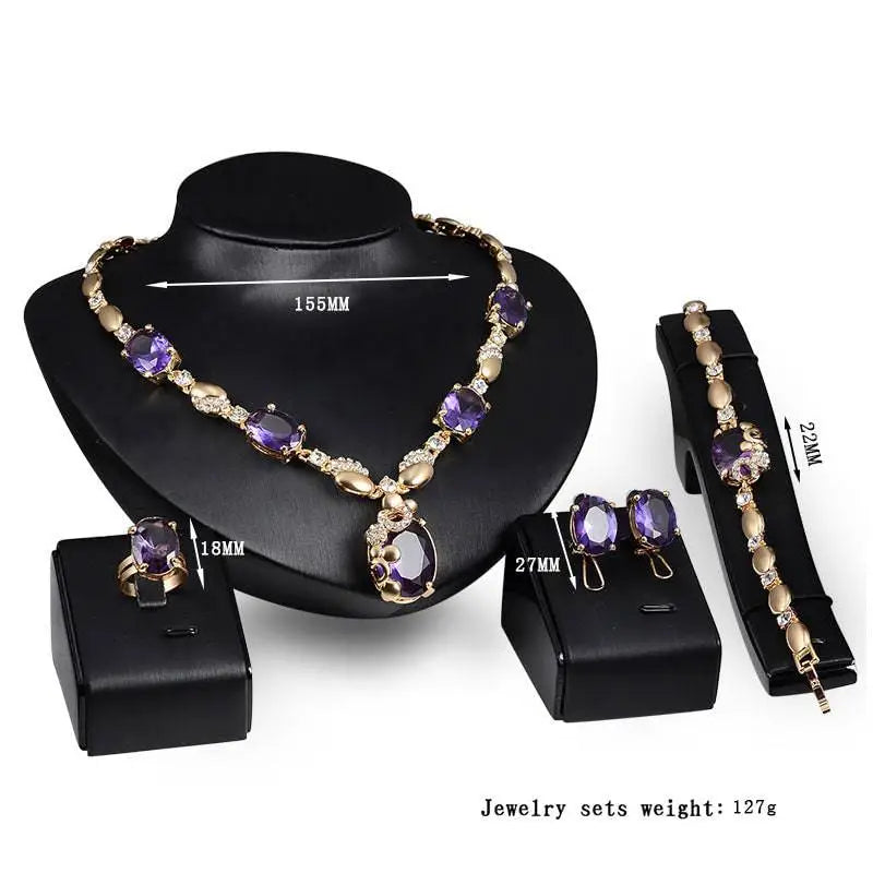 Elegant gold-toned purple amethyst united states fashion jewelry set with oval-cut stones and clear crystals on black busts