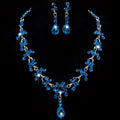 A sparkling blue crystal wedding jewelry necklace and teardrop earrings set with silver metalwork and faceted stones