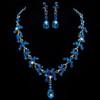 A sparkling blue crystal wedding jewelry necklace and teardrop earrings set with silver metalwork and faceted stones