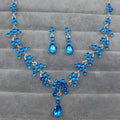 A sparkling blue crystal wedding jewelry necklace and earring set with silver chain and intricate floral designs