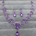 Purple crystal wedding jewelry necklace and earring set with silver-toned metalwork and cascading teardrop stones