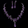Elegant purple crystal wedding necklace and earring set with cascading teardrop and clustered amethyst stones