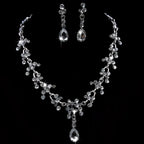 A sparkling silver purple crystal wedding necklace and earring set with floral design and clear crystal accents
