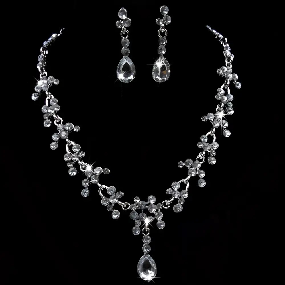 A sparkling silver purple crystal wedding necklace and earring set with floral design and clear crystal accents