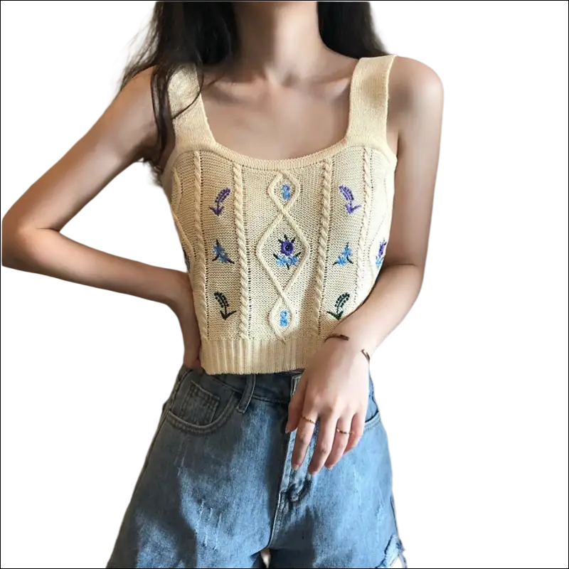 A cream-colored knitted sleeveless embroidered floral camisole with blue floral embroidery and diamond cable knit design