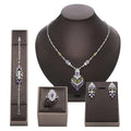 Elegant silver-toned purple floral color zirconium necklace earrings set with matching ring and bracelet featuring gemstones