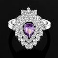 A silver-toned ring with a pear-shaped amethyst and cubic zirconia in a purple floral color zirconium necklace earrings set