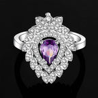 A silver-toned ring with a pear-shaped amethyst and cubic zirconia in a purple floral color zirconium necklace earrings set