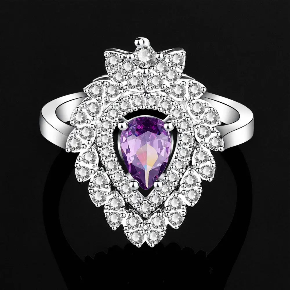 A silver-toned ring with a pear-shaped amethyst and cubic zirconia in a purple floral color zirconium necklace earrings set