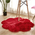 Vibrant red plush faux fur rug with a cloud-like shape for a purple floral shape artificial woolen carpet