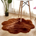 A plush rust-colored floral shape artificial woolen carpet rug with soft fluffy texture and irregular edges