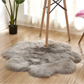 Gray faux fur area rug with soft fluffy texture and irregular circular shape for purple floral shape artificial woolen carpet
